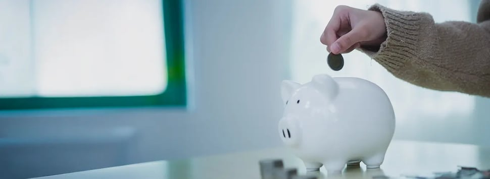 Putting a coin on a piggy bank
