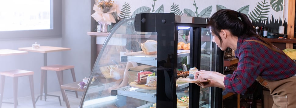 a business owner arranging baked goods