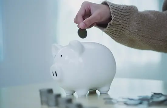 Putting a coin on a piggy bank